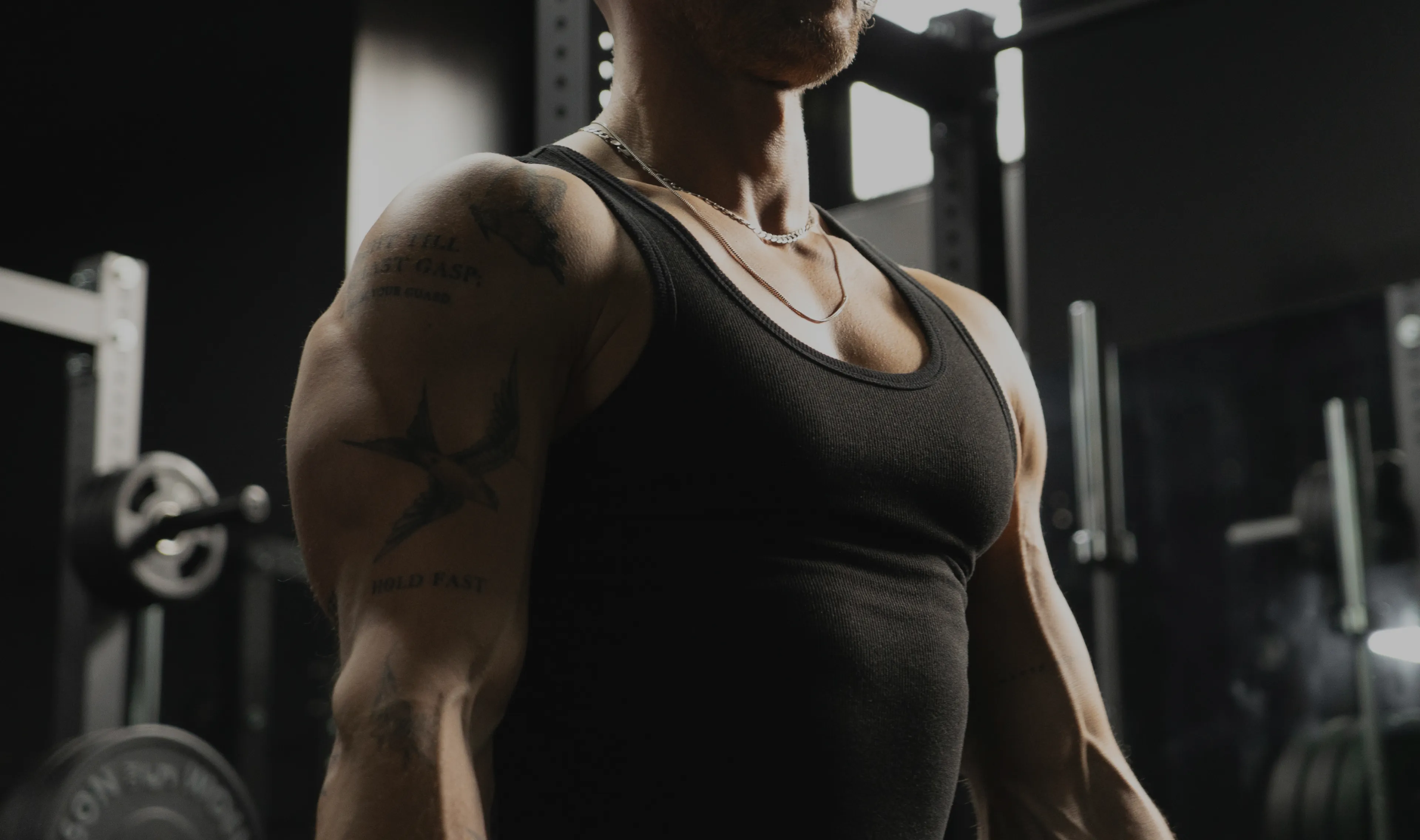A Lift client standing in a dimly lit gym between sets.